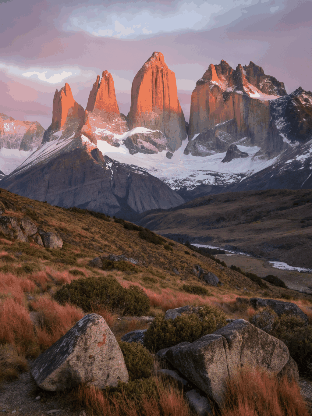 Granite horns of Cuernos del Paine glowing with intense amber alpenglow